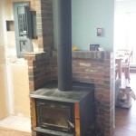 Wood stove heat shield reduces clearances by 66%