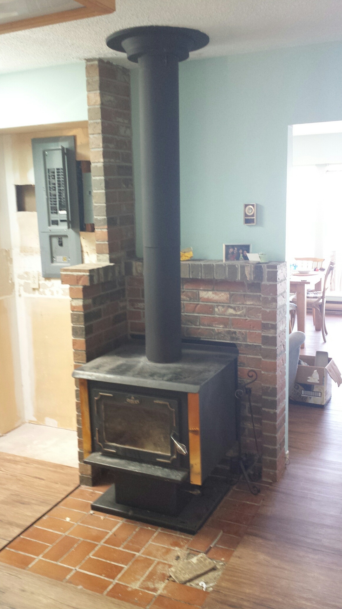 Wood stove heat shield reduces clearances by 66%